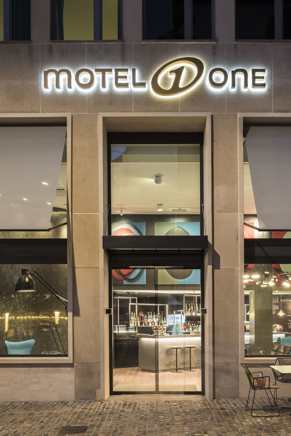 hotel Basel Motel One view from outside of the hotel entrance area with seating