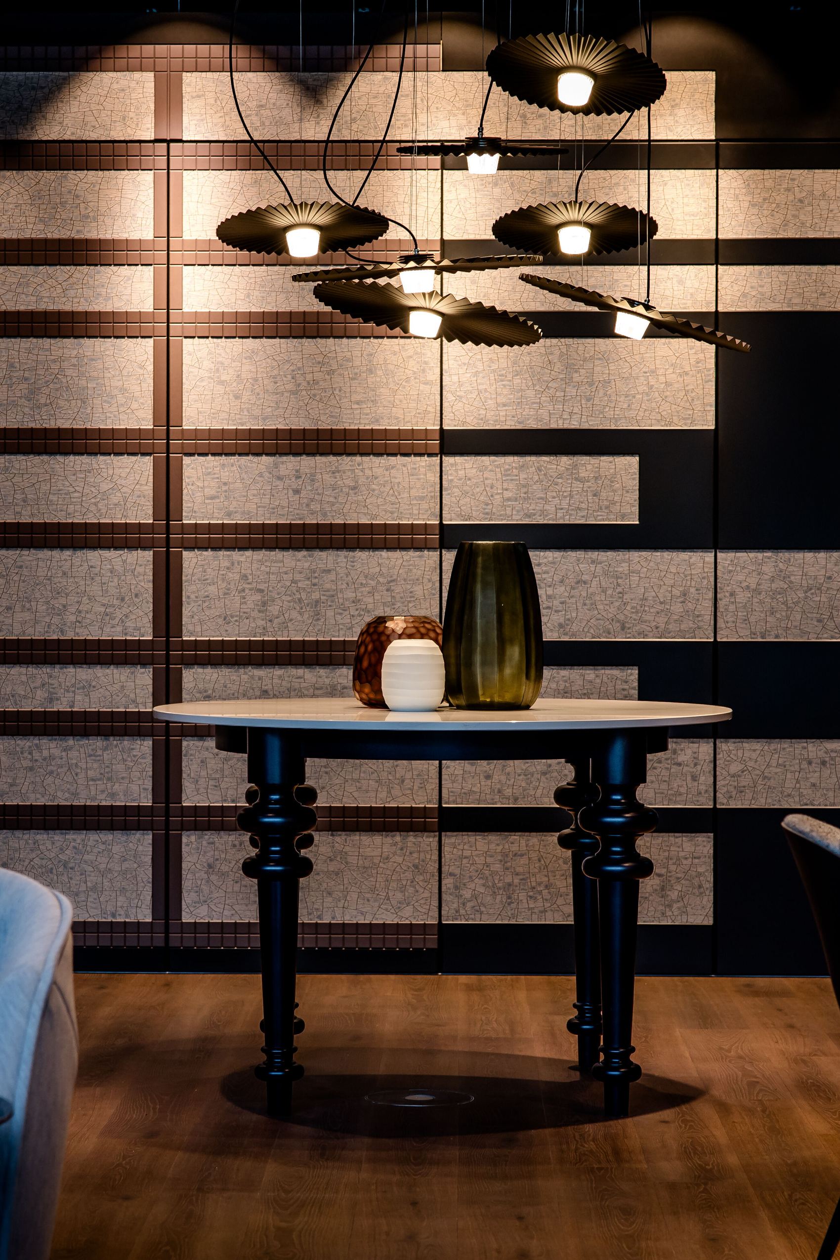 hotel Karlsruhe Motel One view of round table in front of large wall and chairs to the left and right of the picture