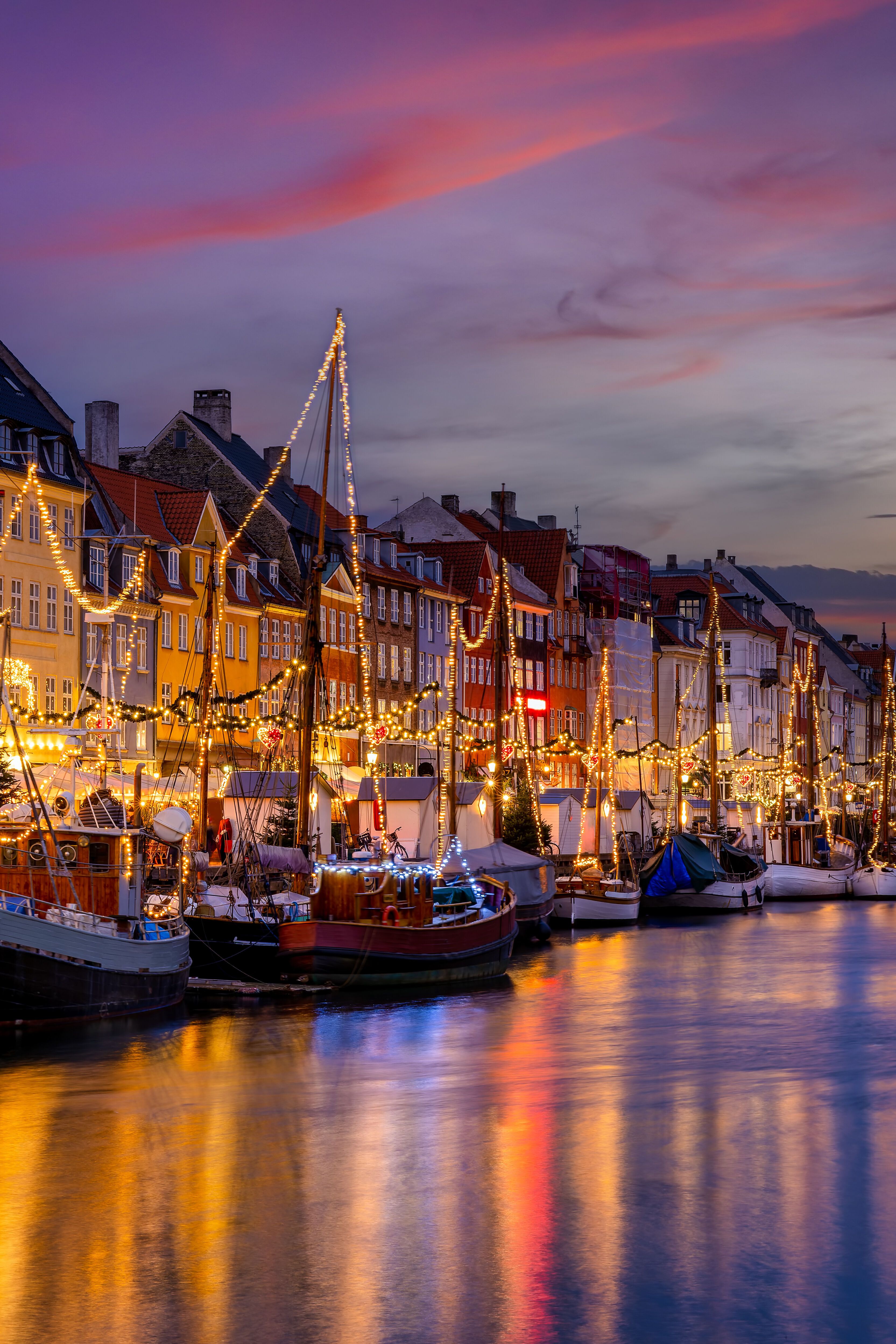 Copenhagen in winter with river, illuminated ships and houses Copenhagen in winter with river, illuminated ships and houses