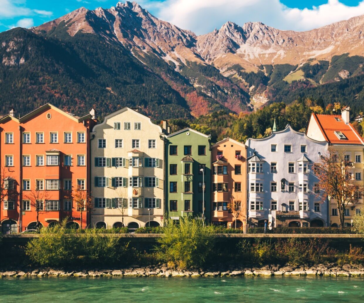 hotels Innsbruck view of houses on the water's edge of the Inn and mountain panorama in the background