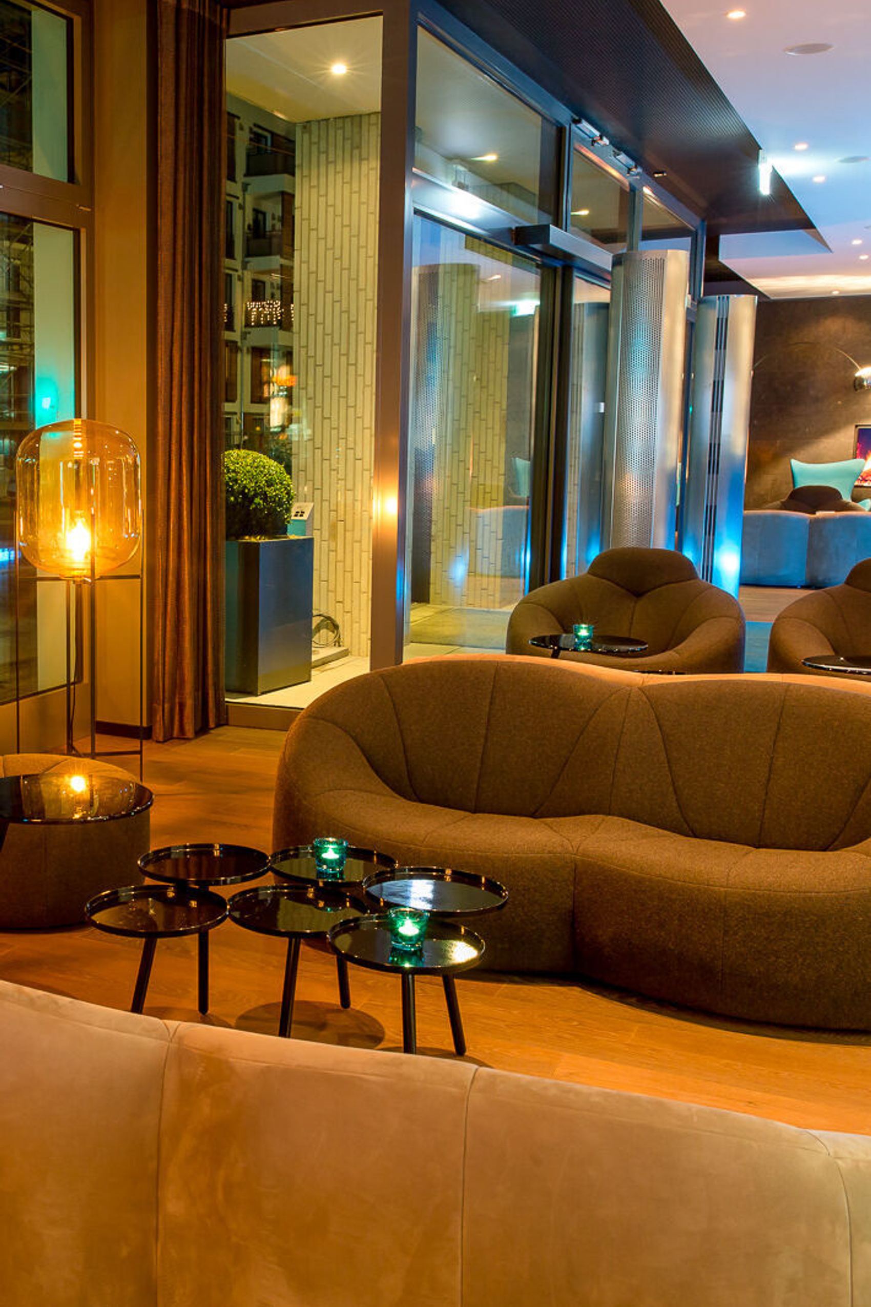 designhotel Munich Olympia Gate Motel One lounge in the evening with armchairs