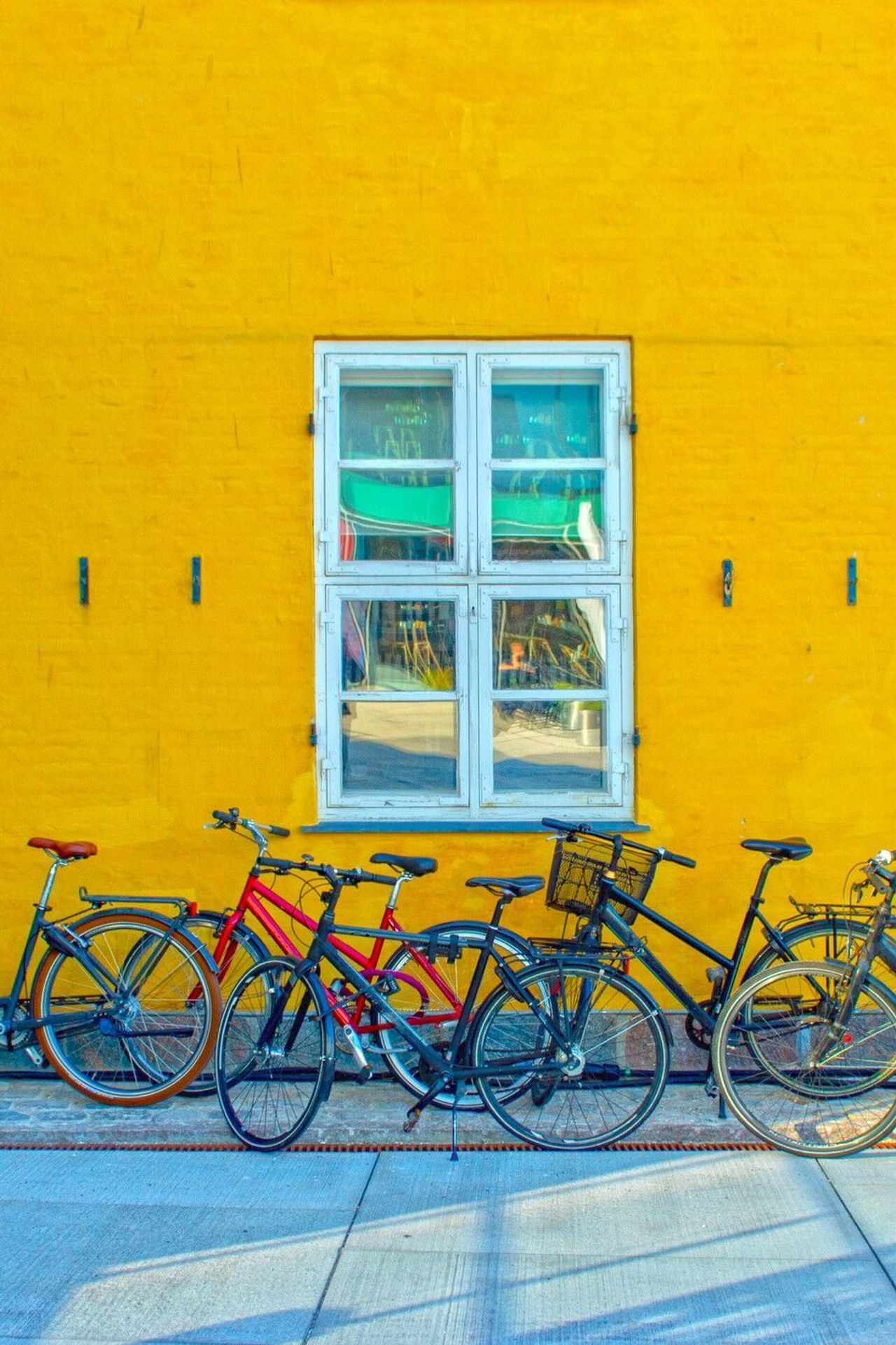 designhotel Copenhagen Motel One several bicycles in front of a yellow house wall