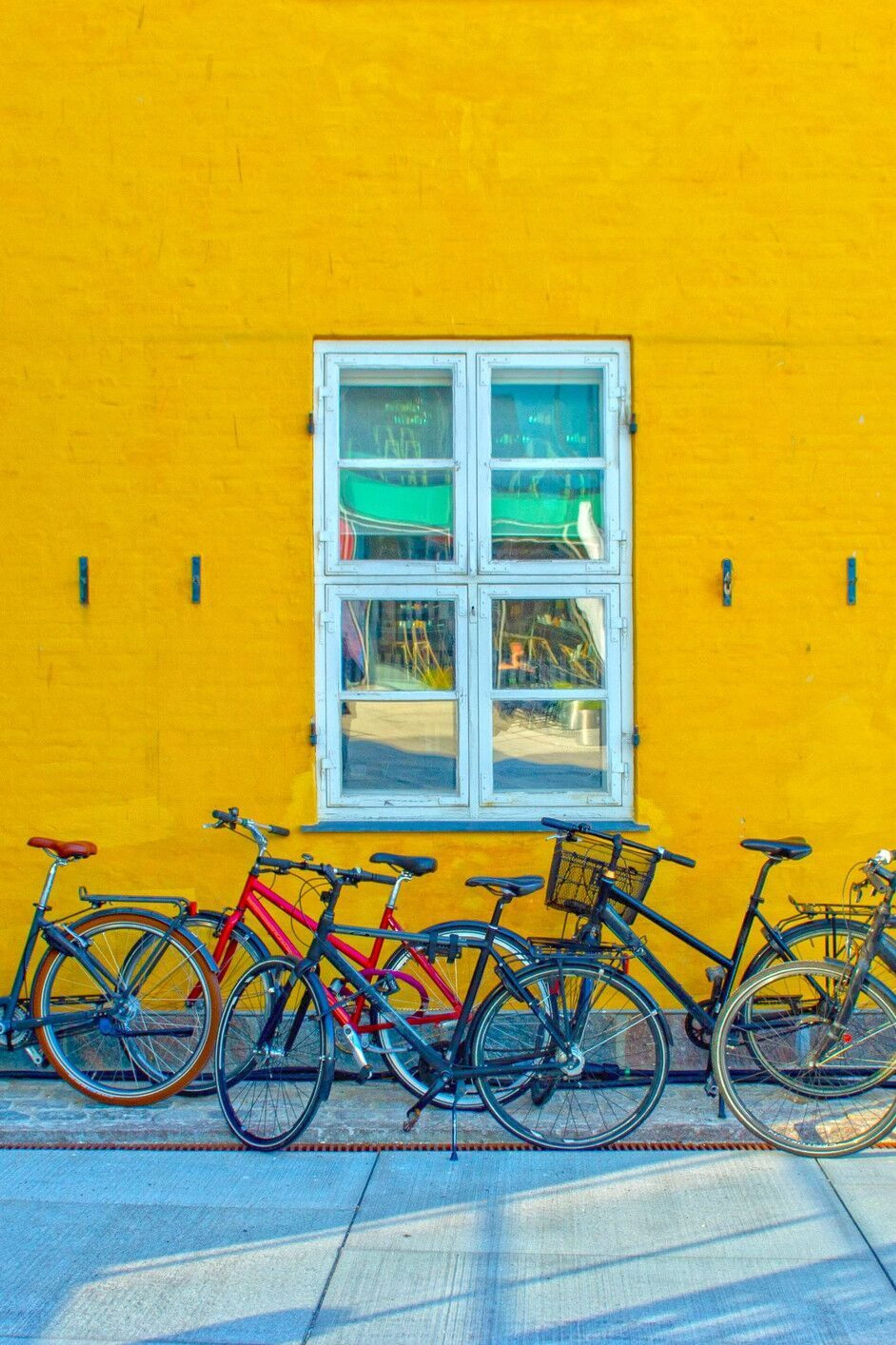 designhotel Copenhagen Motel One several bicycles in front of a yellow house wall