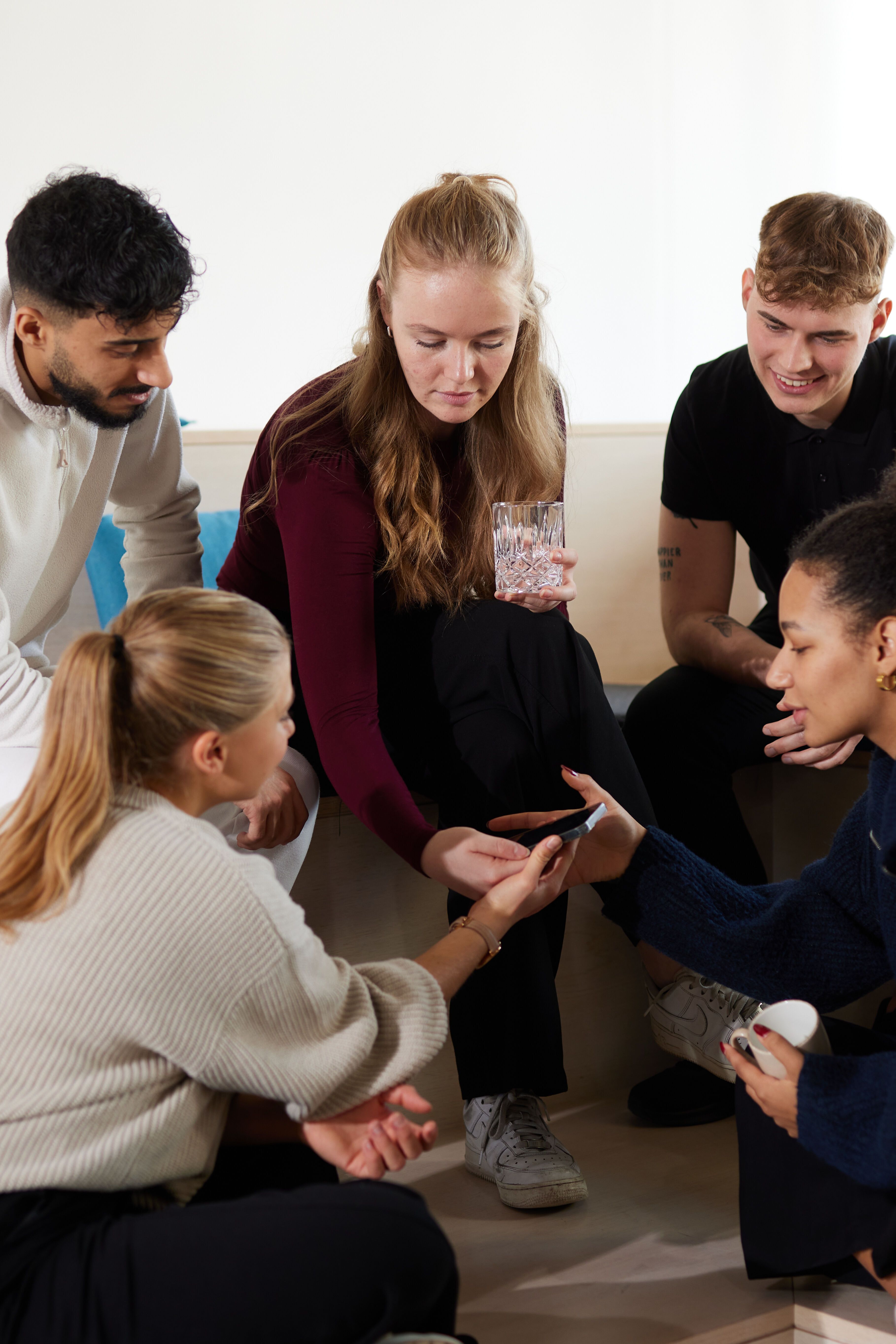 Motel One Work & study students chatting together and checking their phones Motel One Work & study students chatting together and checking their phones