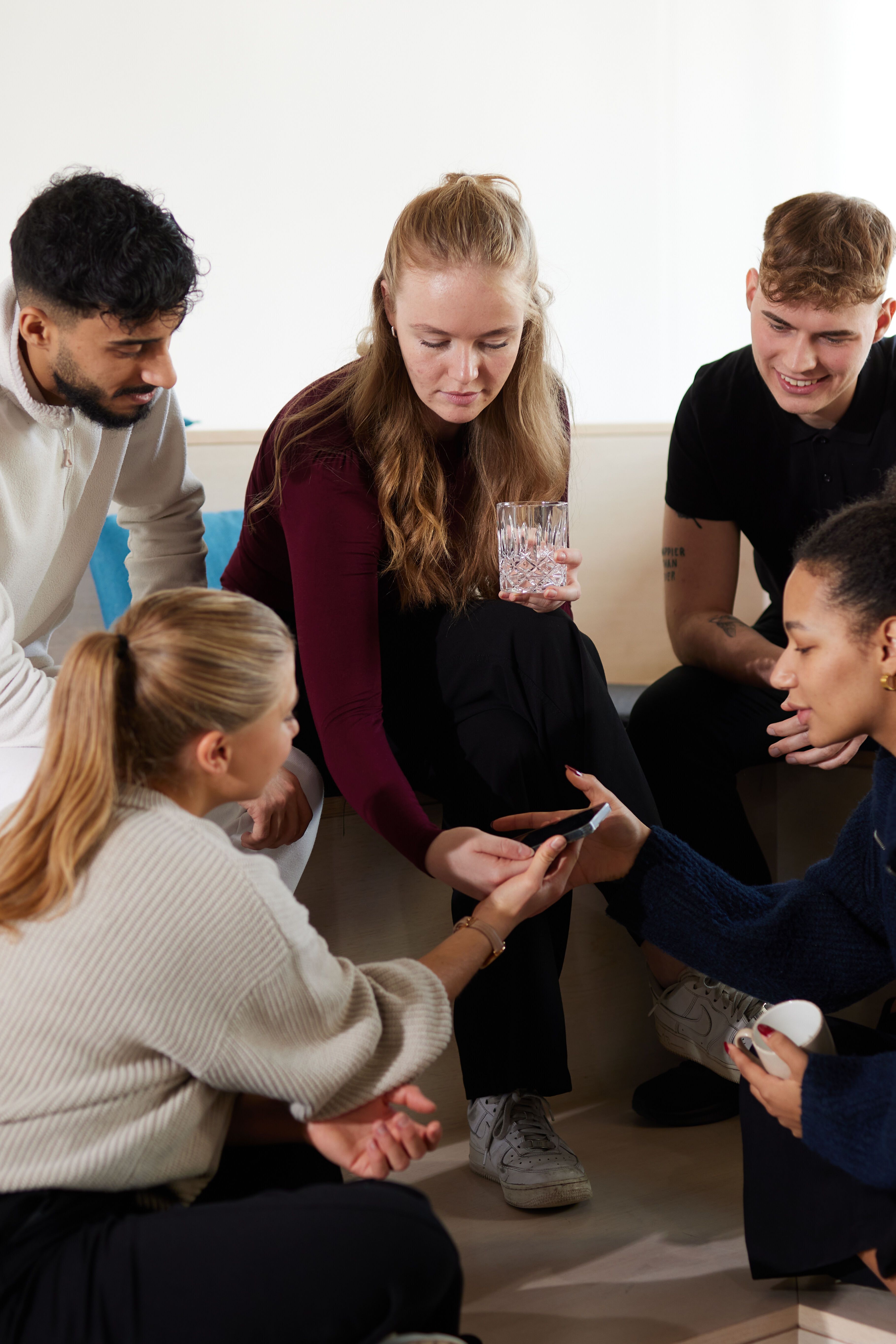 Motel One Work & study students chatting together and checking their phones