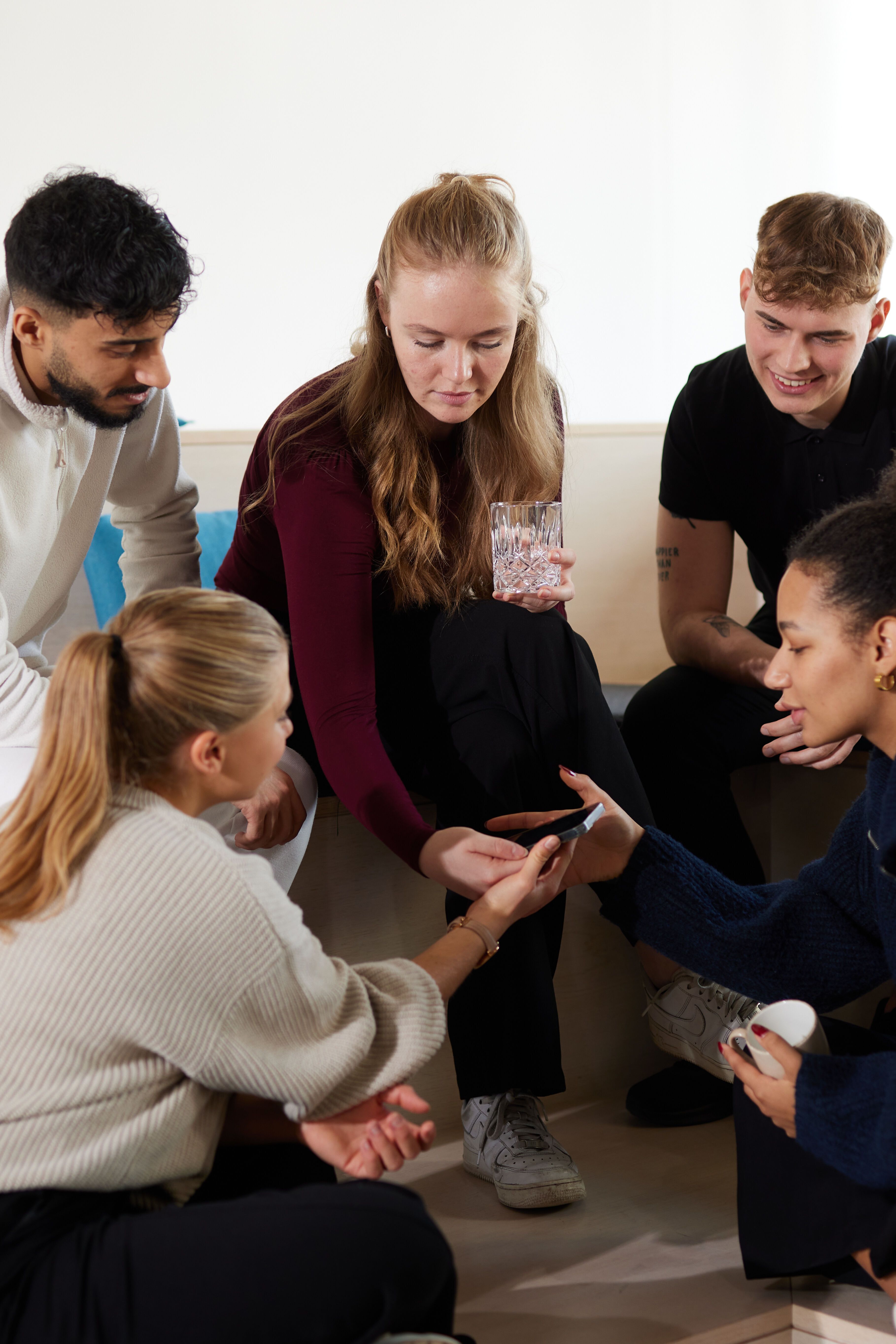Motel One Work & study students chatting together and checking their phones Motel One Work & study students chatting together and checking their phones
