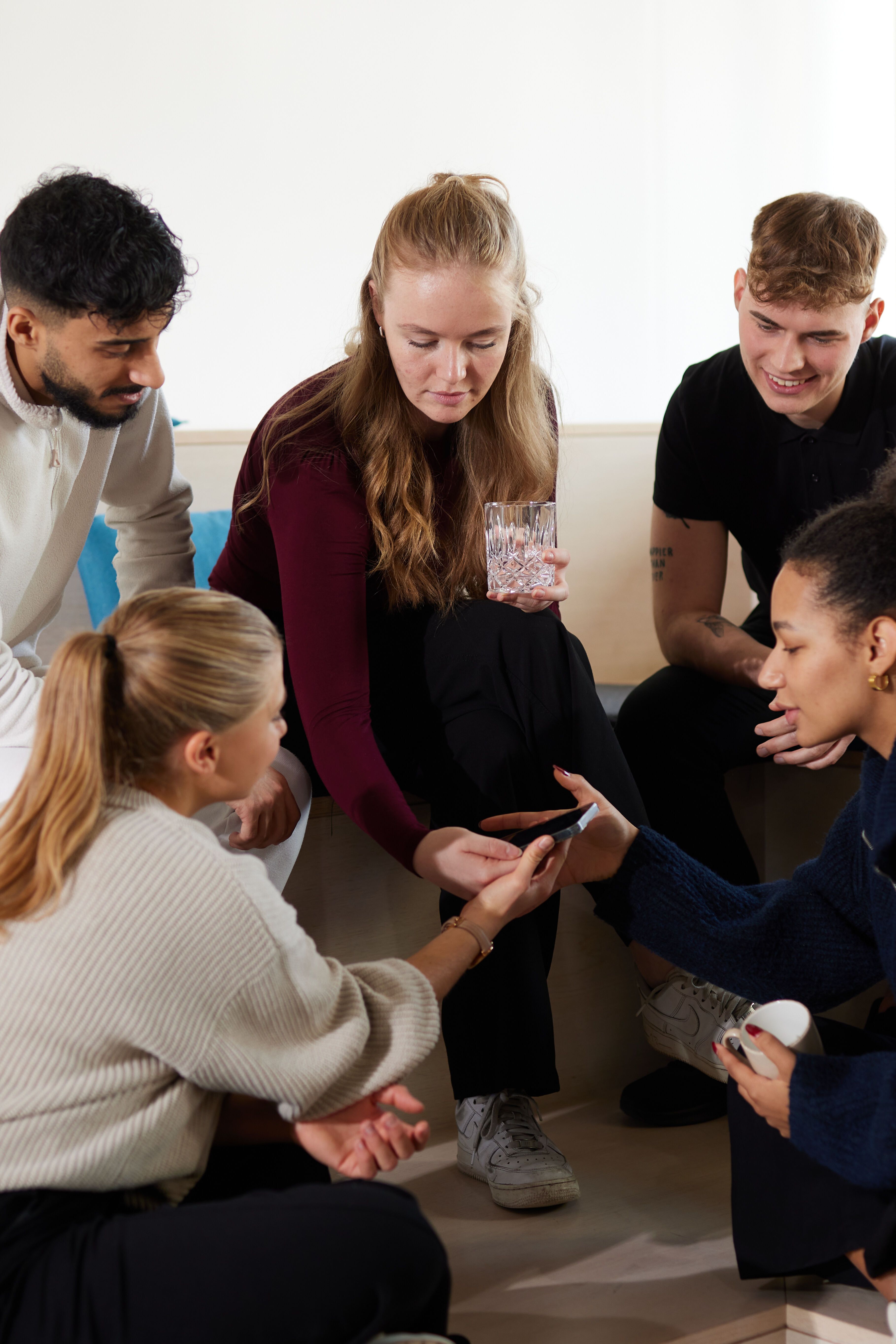 Motel One Work & study students chatting together and checking their phones