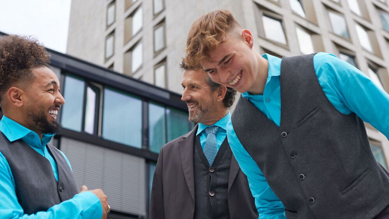 Joel laughing together with colleagues