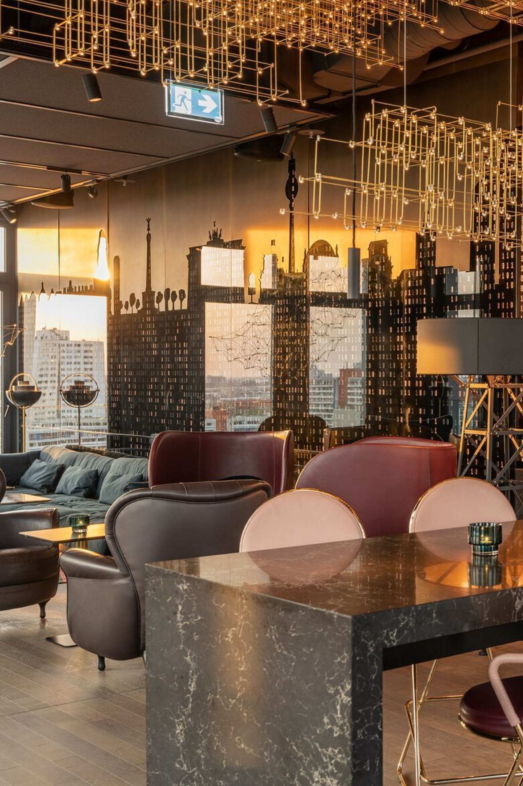 hotel Berlin Alexanderplatz Motel One bright lounge with a long high table and chairs in the foreground and a bar in the background