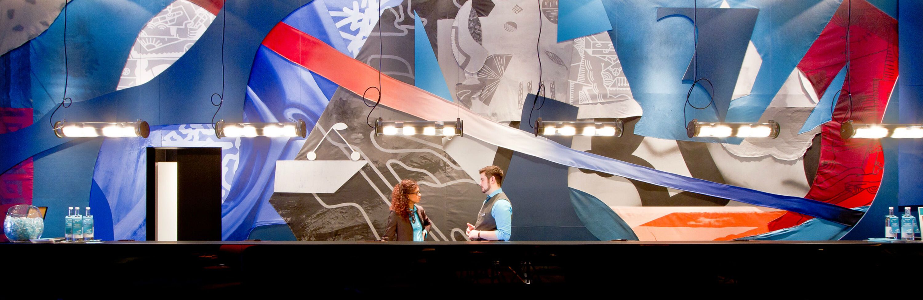 hotel Berlin Alexanderplatz Motel One large reception area with two employees talking to each other